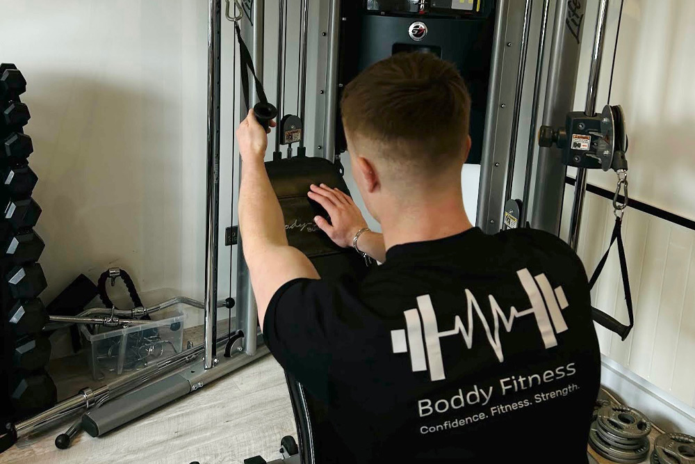 Man using cable machine at home