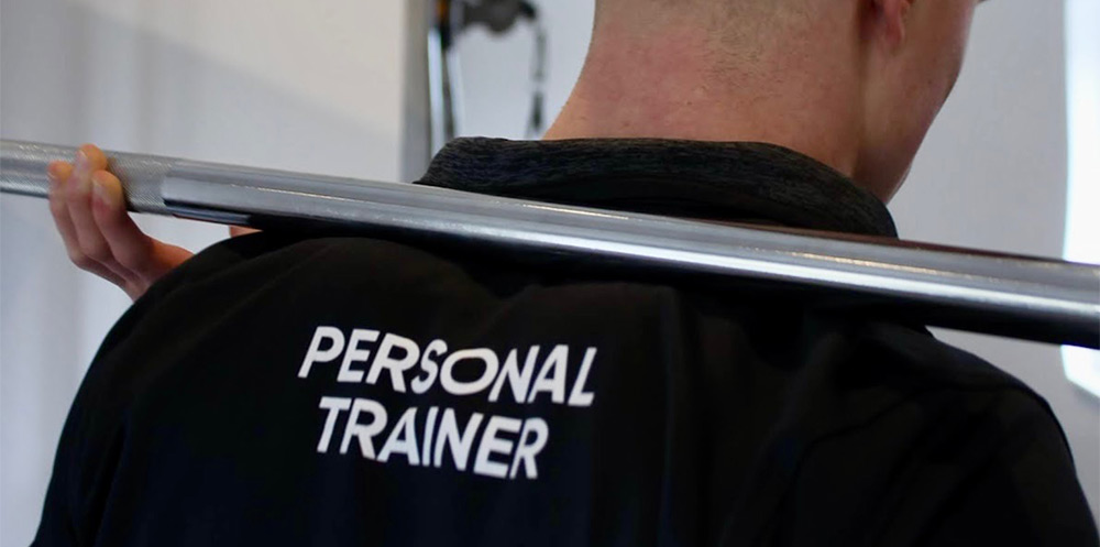 Close up of man with personal trainer labelled shirt